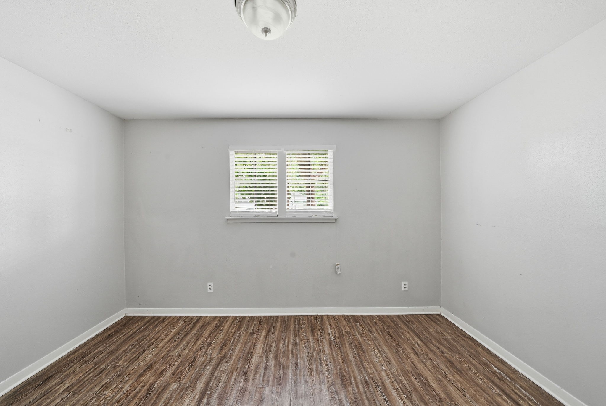 6410 Hopper Road Houston, TX 77016 - Photo 23 of 28 an empty room with wooden floor and windows