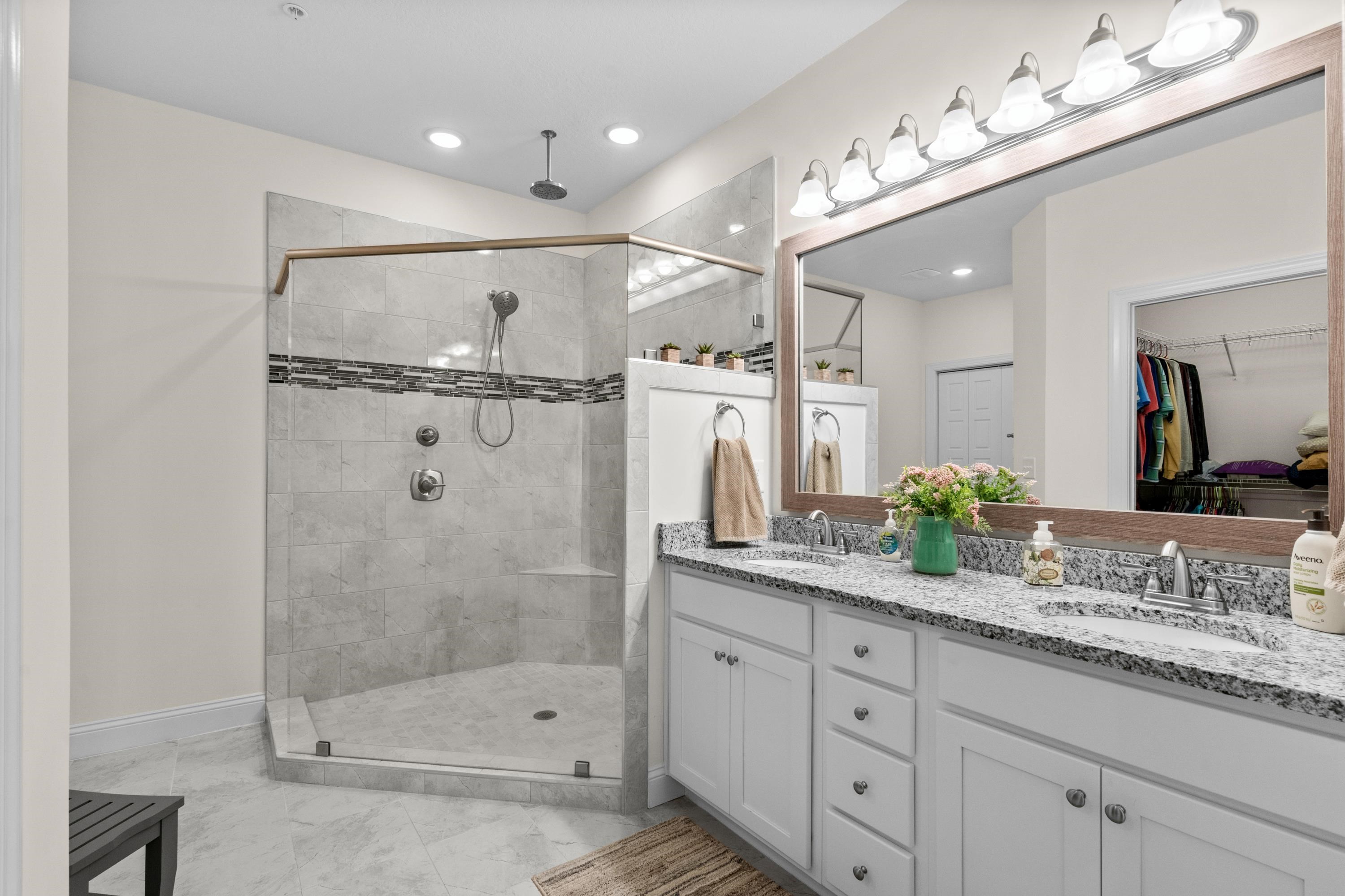 948 Jackline Place, Unit 201 Murrells Inlet, SC 29576 - Photo 23 of 37 Bathroom featuring a walk in closet, double vanity, and a shower stall