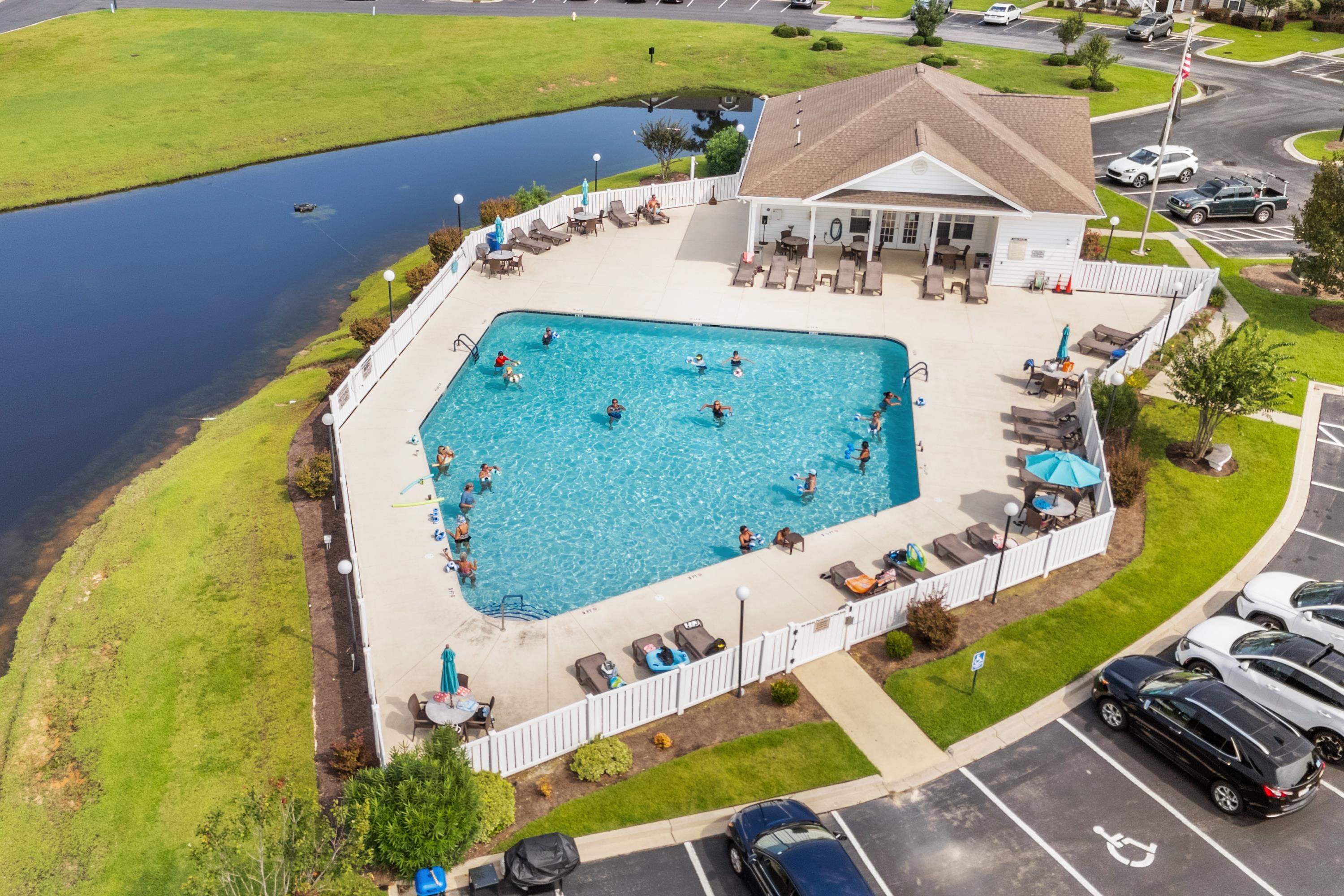 948 Jackline Place, Unit 201 Murrells Inlet, SC 29576 - Photo 29 of 37 Drone / aerial view of a nearby body of water and a pool area
