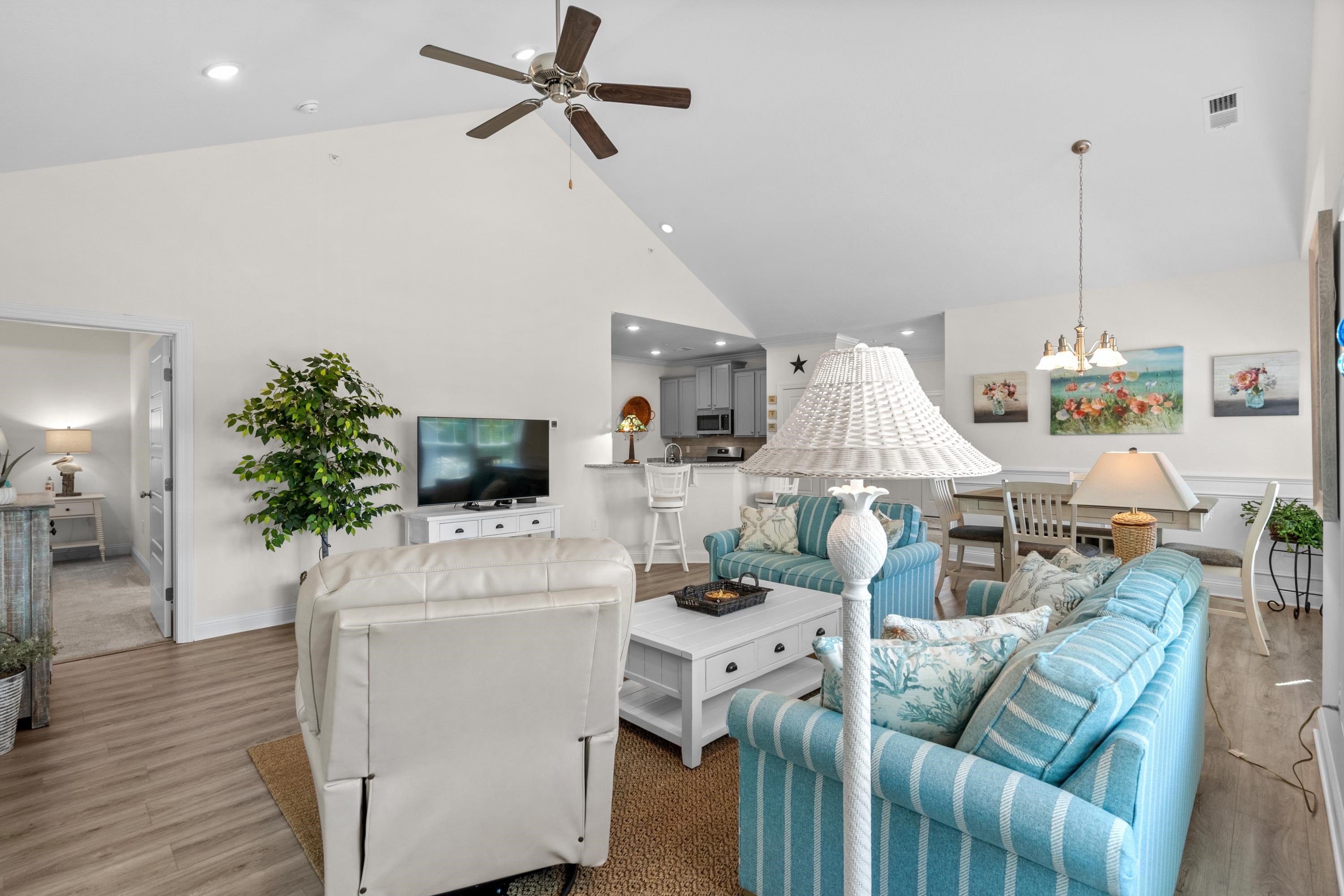 948 Jackline Place, Unit 201 Murrells Inlet, SC 29576 - Photo 7 of 37 Living area with high vaulted ceiling, wood finished floors, a ceiling fan, and a chandelier