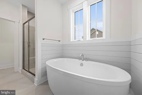 a white bath tub sitting next to a window