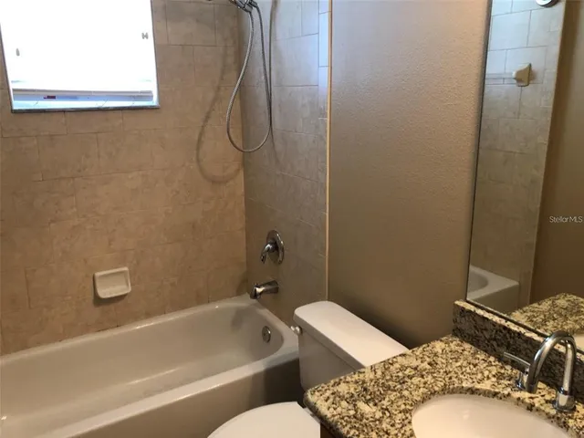 a bathroom with a tub and a shower