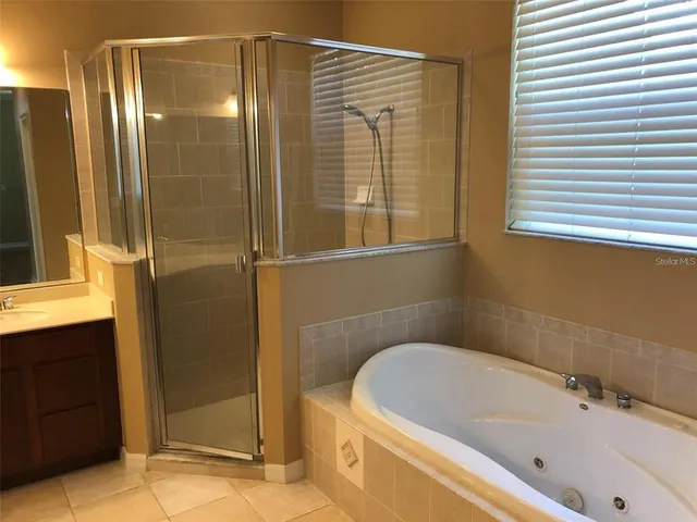 a bathroom with a bathtub and a shower