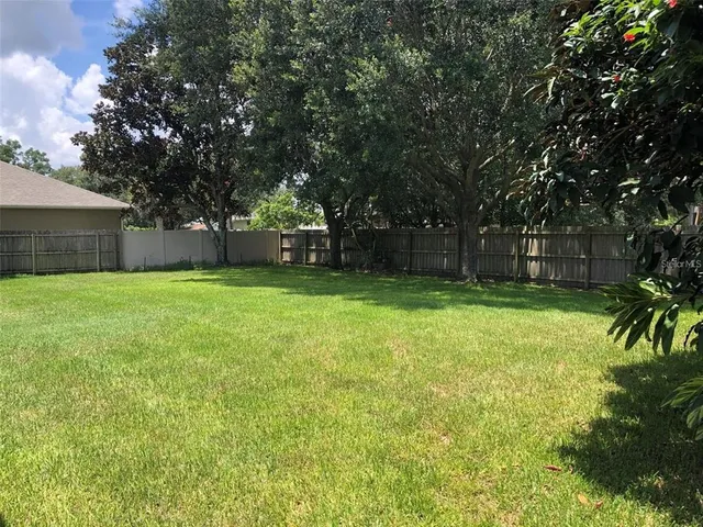 a view of a yard with a house in the background