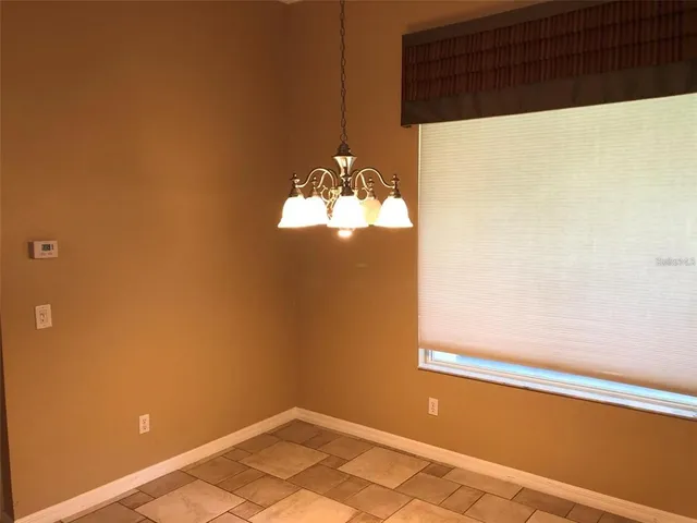 a view of a chandelier fan and window