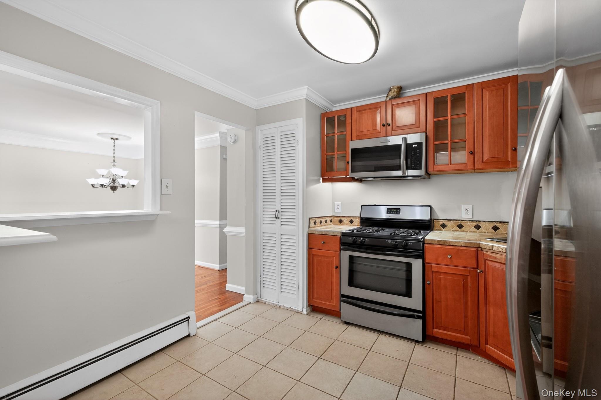 138 Spring Street Massapequa, NY 11758 - Photo 11 of 45 a kitchen with stainless steel appliances granite countertop a stove top oven a sink and dishwasher