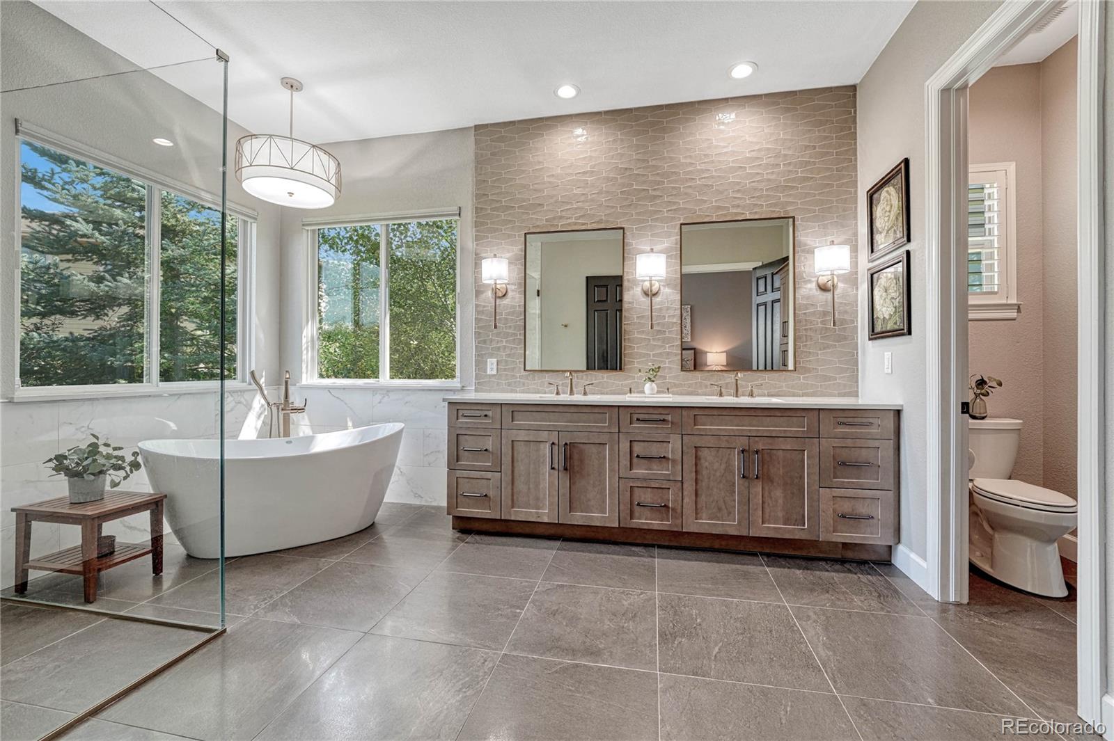 20125 East Shady Ridge Road Parker, CO 80134 - Photo 15 of 40 a large spacious bathroom with a large tub shower and sink