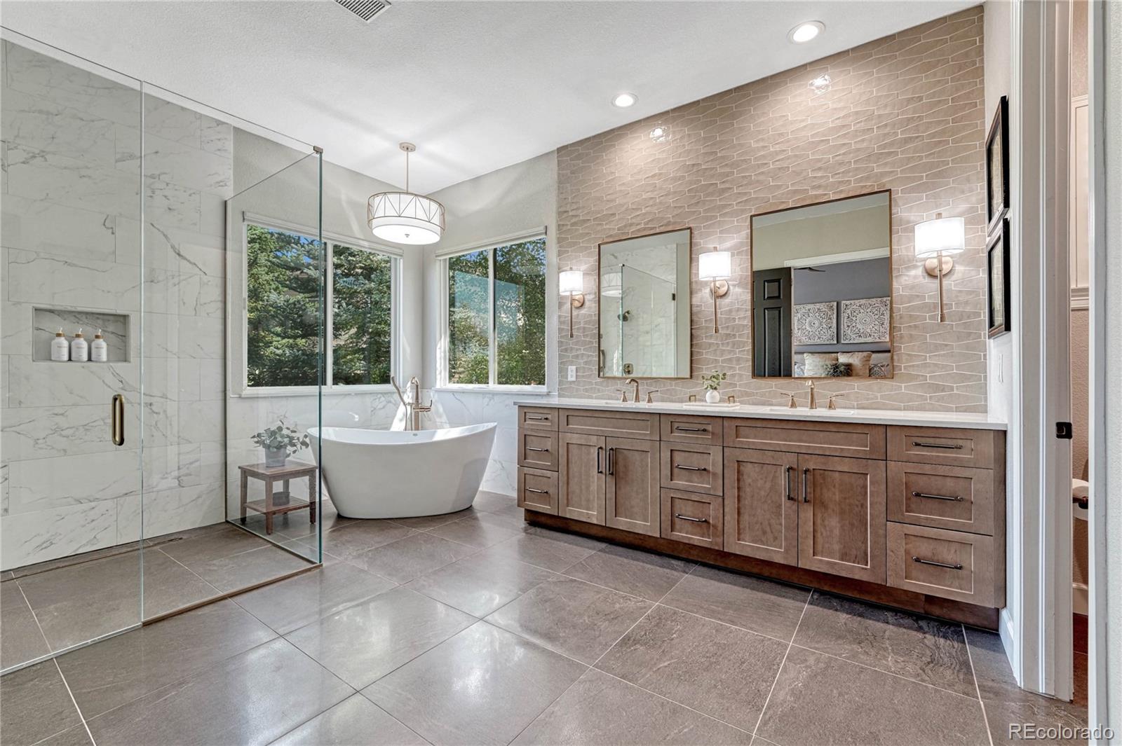 20125 East Shady Ridge Road Parker, CO 80134 - Photo 16 of 40 a spacious bathroom with a large tub shower and sink