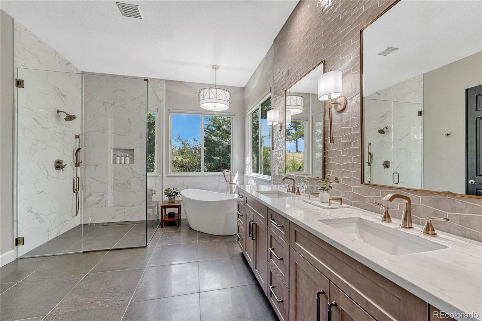 20125 East Shady Ridge Road Parker, CO 80134 - Photo 18 of 40 a large bathroom with a tub sink shower and mirror