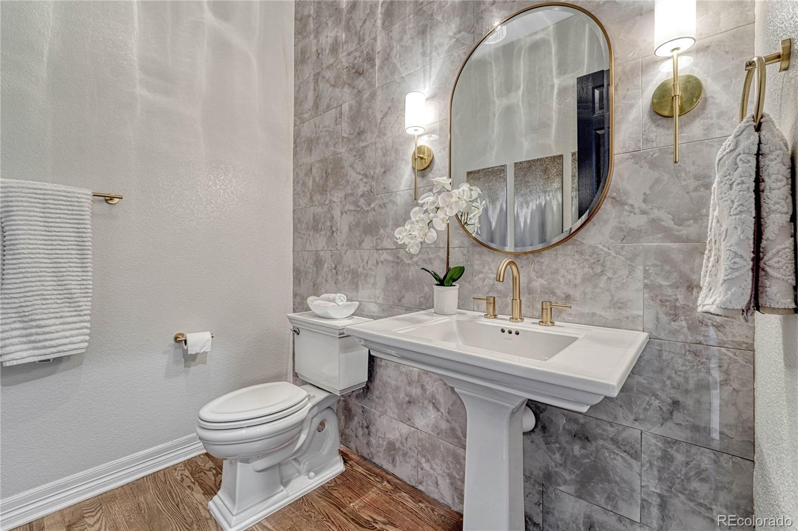 20125 East Shady Ridge Road Parker, CO 80134 - Photo 22 of 40 a bathroom with a sink a toilet and a mirror