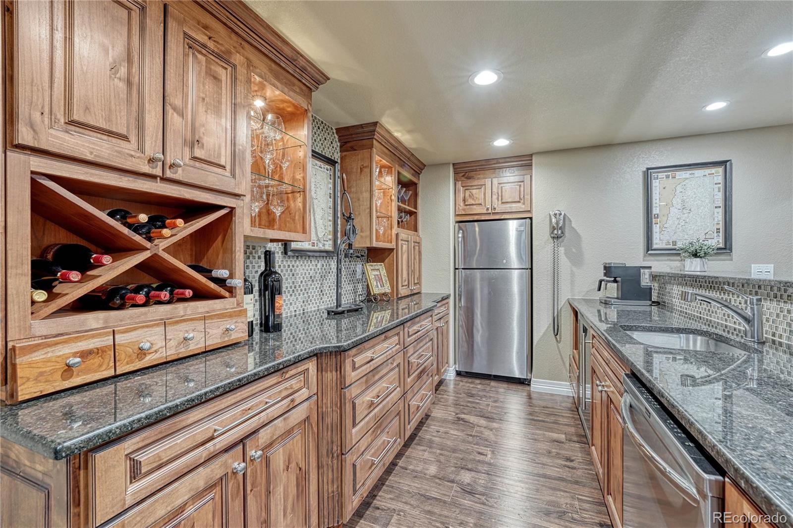 20125 East Shady Ridge Road Parker, CO 80134 - Photo 25 of 40 a kitchen with stainless steel appliances granite countertop a sink stove and refrigerator