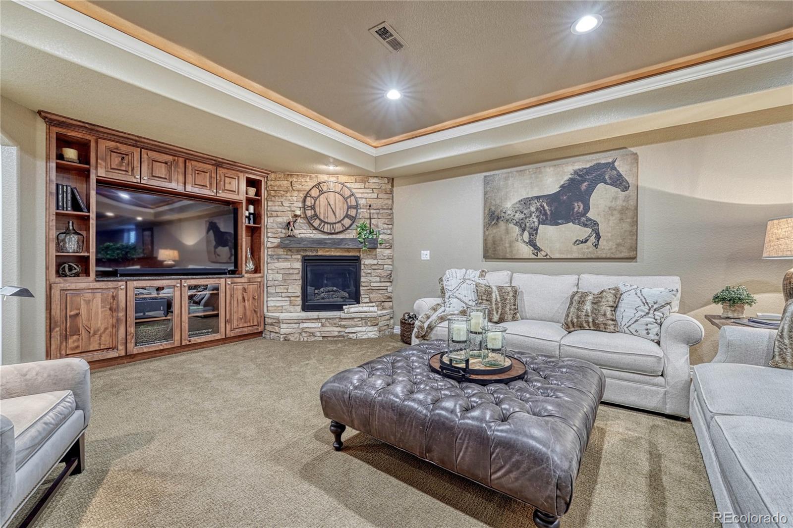 20125 East Shady Ridge Road Parker, CO 80134 - Photo 28 of 40 a living room with furniture and a flat screen tv