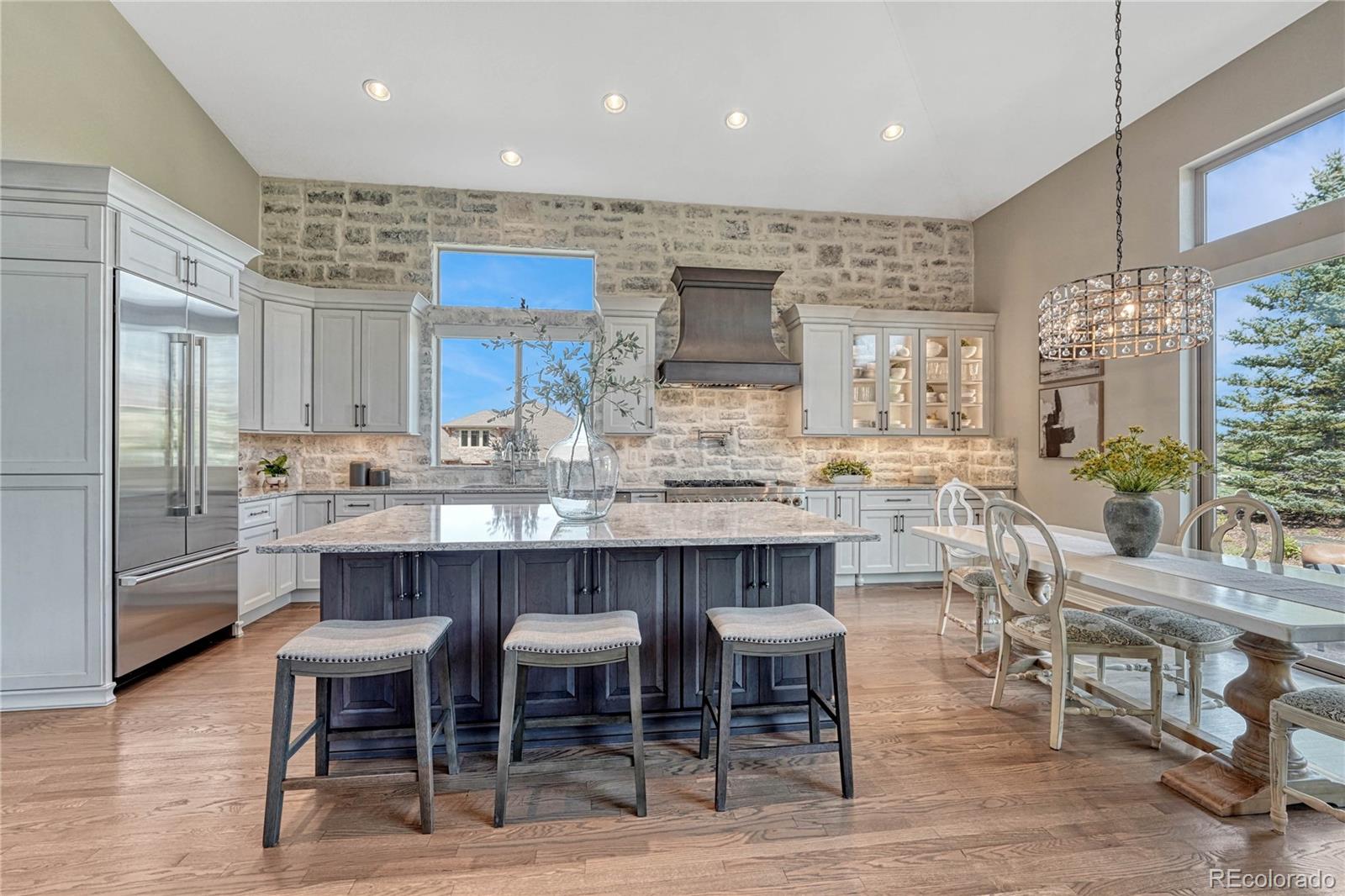 20125 East Shady Ridge Road Parker, CO 80134 - Photo 3 of 40 an open kitchen with granite countertop and chairs