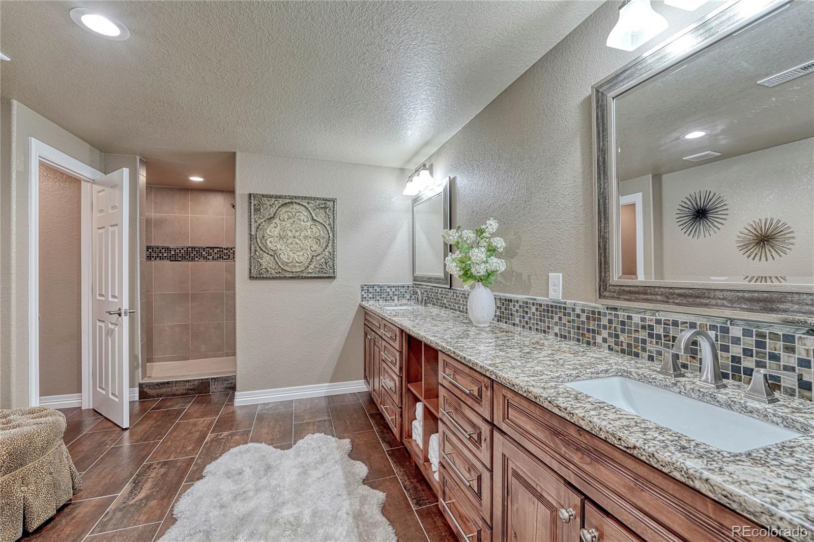 20125 East Shady Ridge Road Parker, CO 80134 - Photo 31 of 40 a bathroom with a granite countertop double vanity sink and a mirror