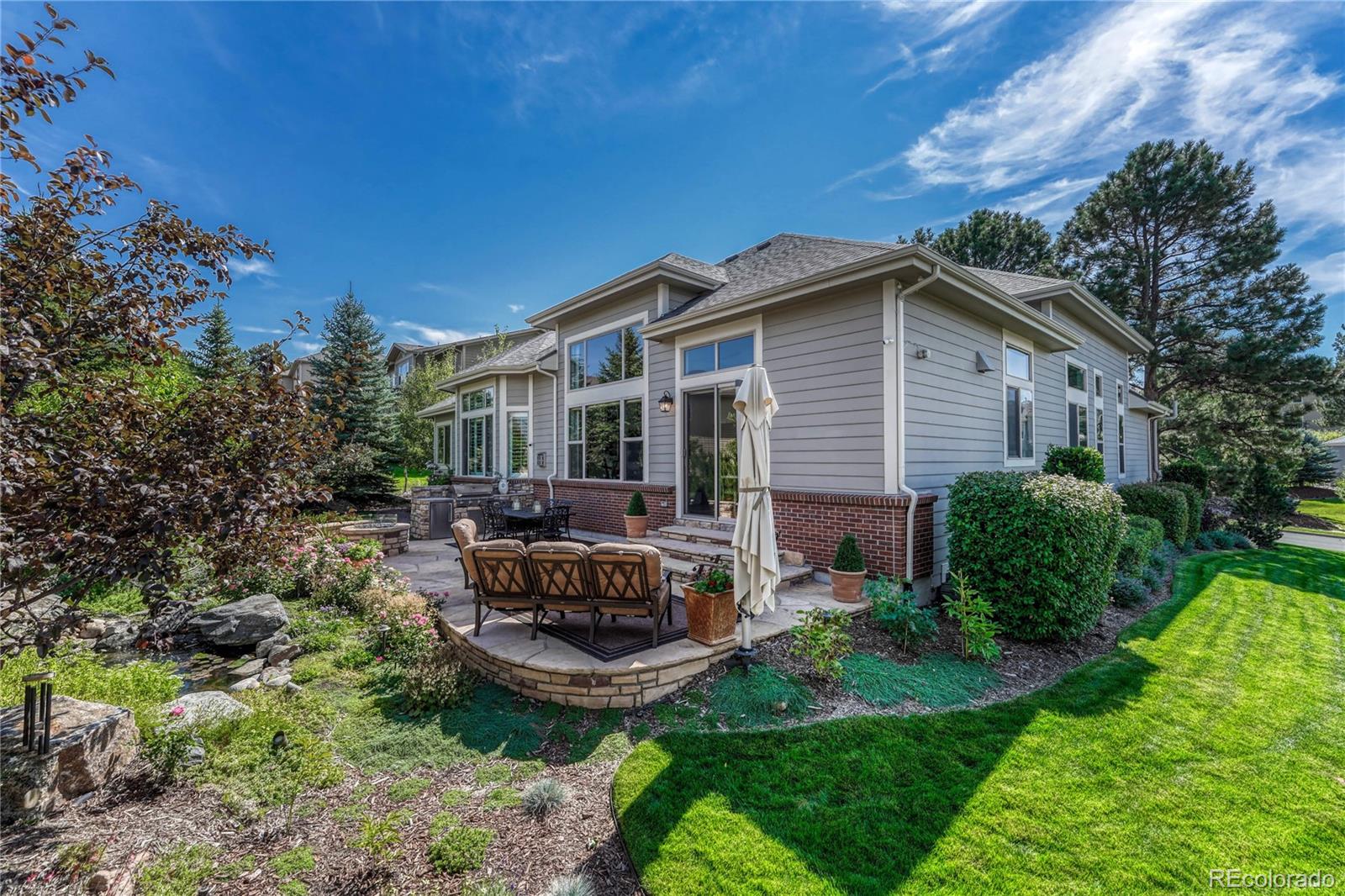20125 East Shady Ridge Road Parker, CO 80134 - Photo 38 of 40 a view of a house with backyard sitting area and garden