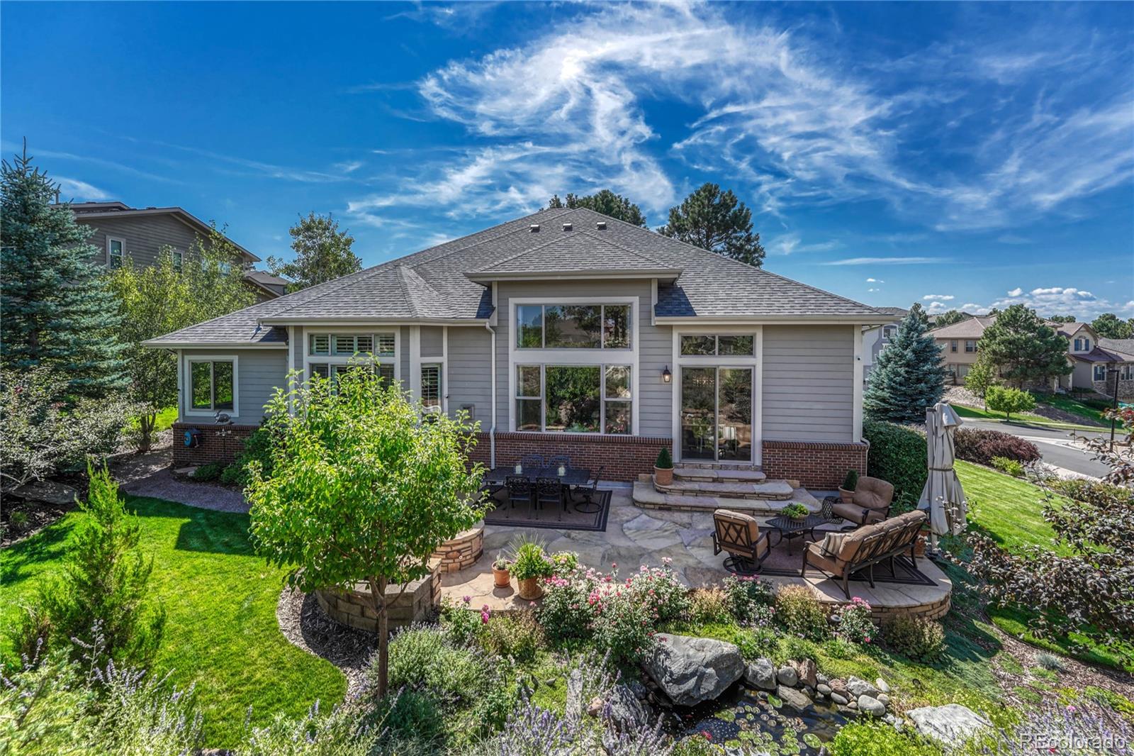 20125 East Shady Ridge Road Parker, CO 80134 - Photo 39 of 40 a front view of a house with a garden