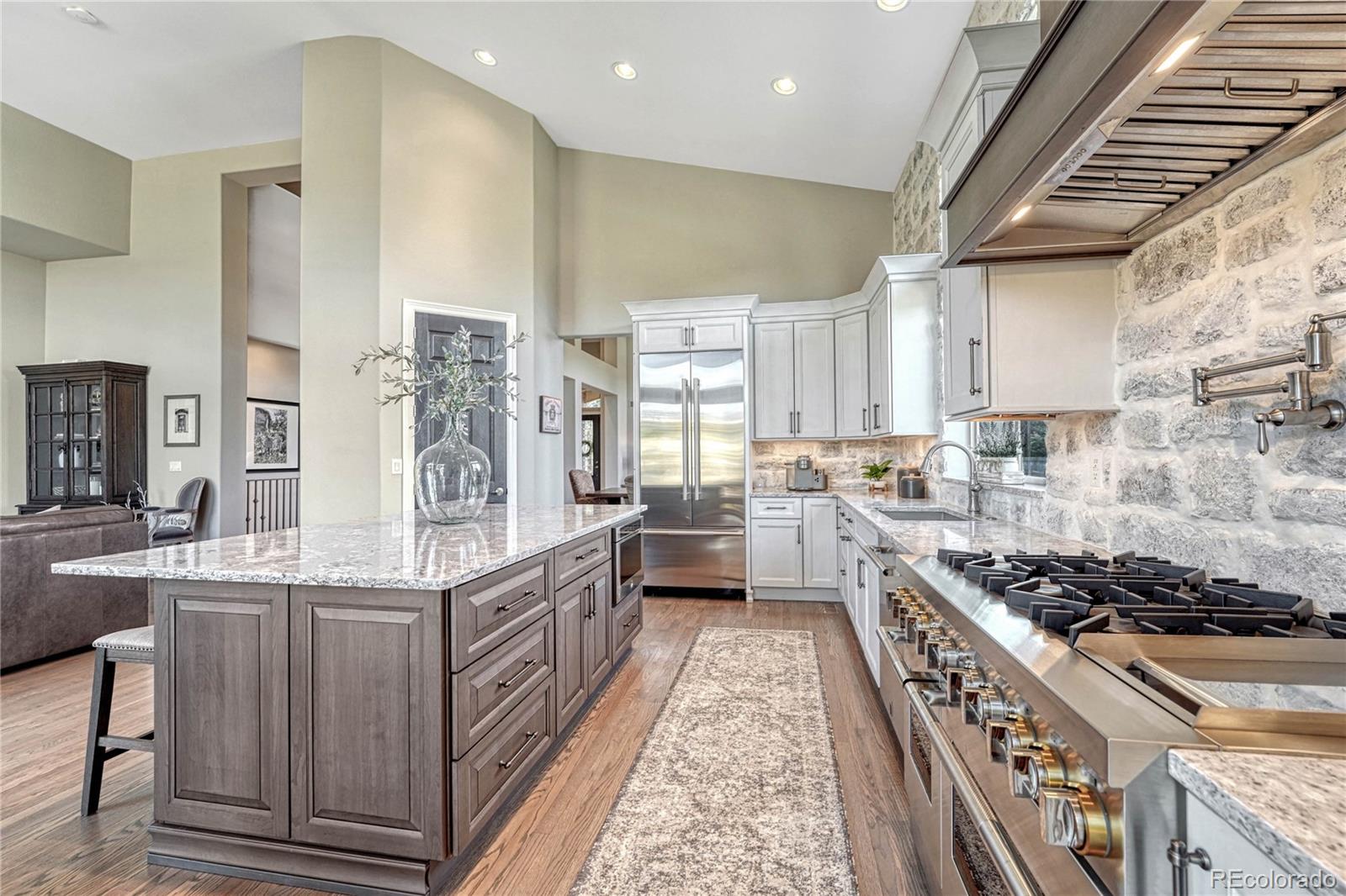 20125 East Shady Ridge Road Parker, CO 80134 - Photo 6 of 40 a kitchen with stainless steel appliances granite countertop a stove a sink and a refrigerator