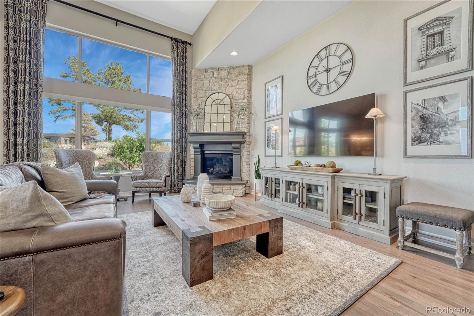 20125 East Shady Ridge Road Parker, CO 80134 - Photo 8 of 40 a living room with furniture a flat screen tv and a fireplace