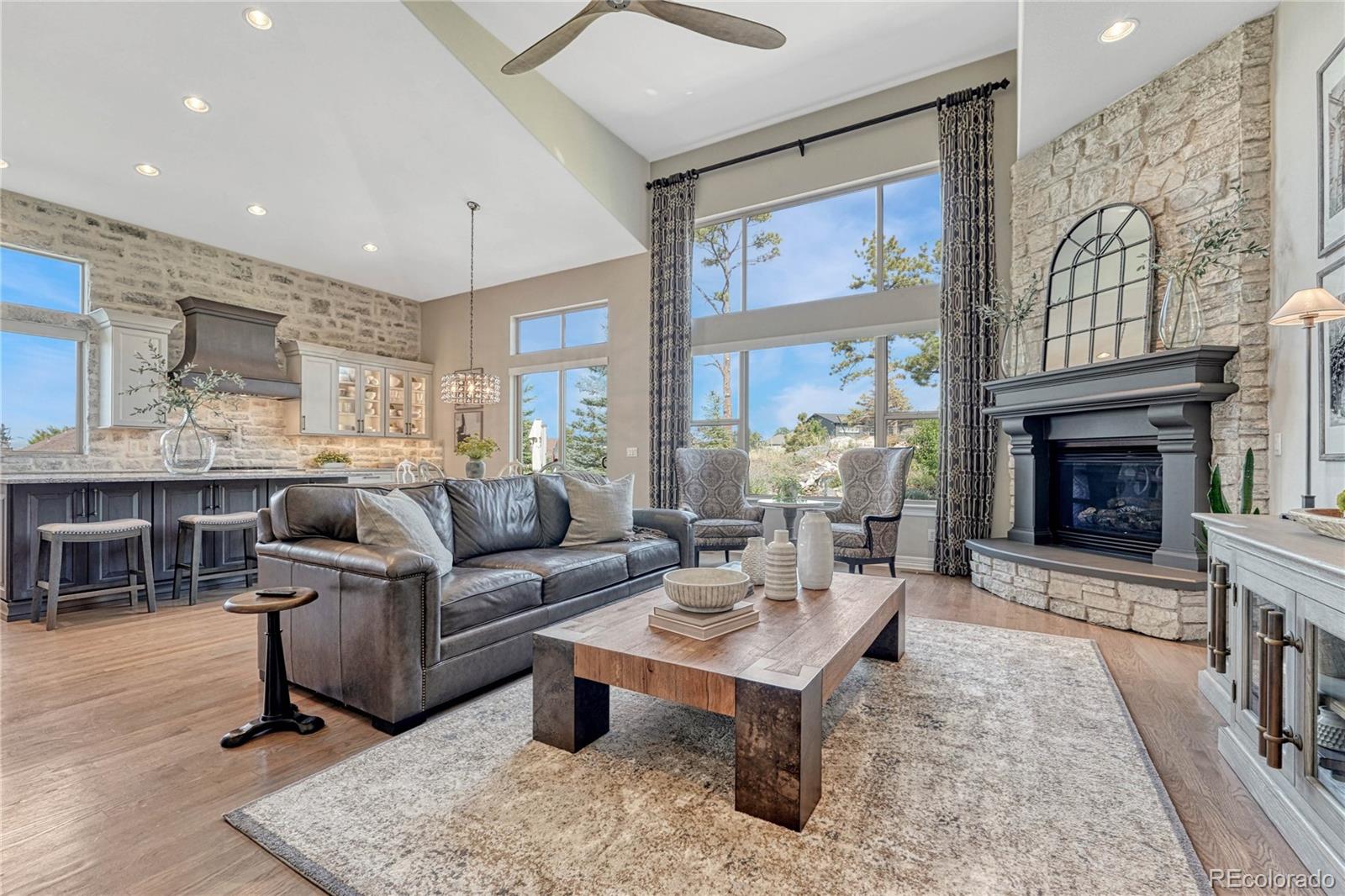 20125 East Shady Ridge Road Parker, CO 80134 - Photo 9 of 40 a living room with furniture a fireplace and a table