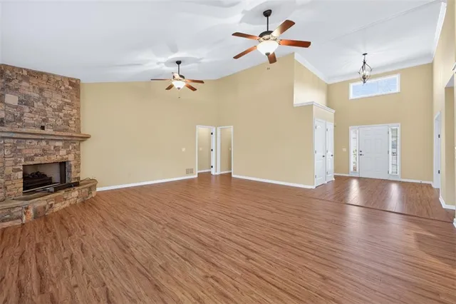 wooden floor in an empty room with a fireplace