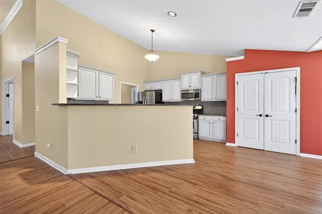 a view of a kitchen with wooden floor