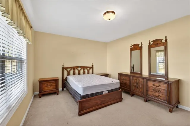a bedroom with a bed table and window