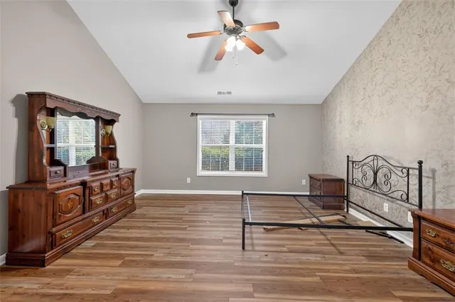a bathroom with a tub a sink a mirror and a shower