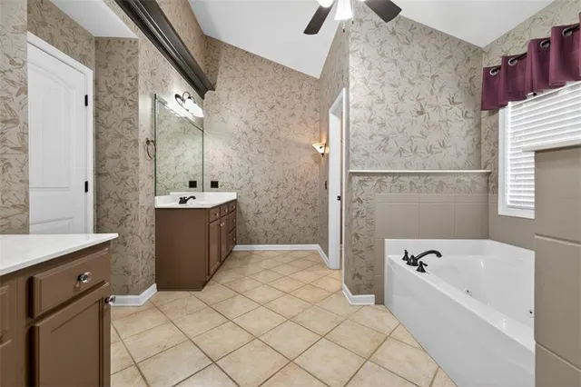a bedroom with wooden floor and large windows