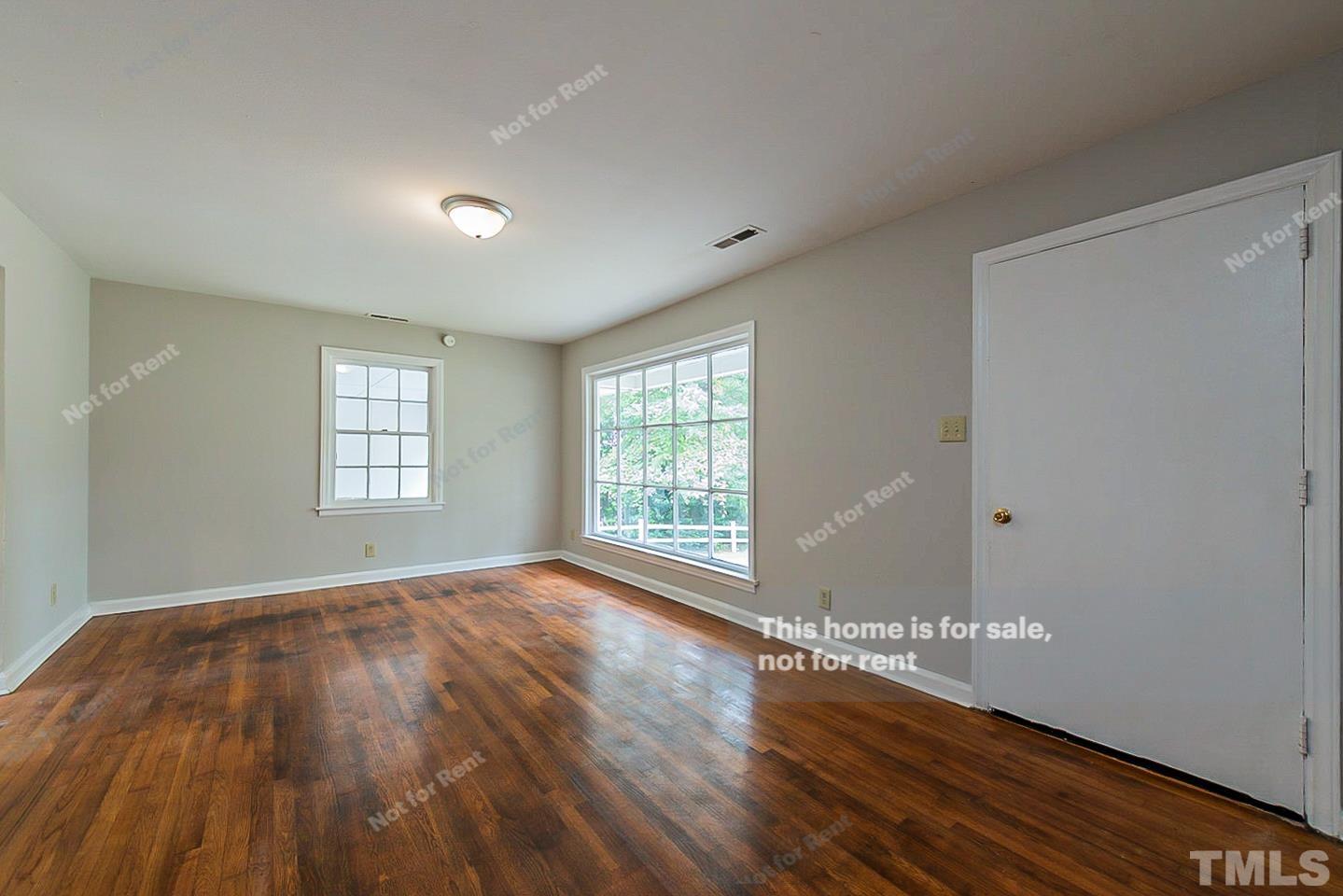 1217 Brighton Road Raleigh, NC 27610 - Photo 3 of 14 a view of an empty room with wooden floor and a window