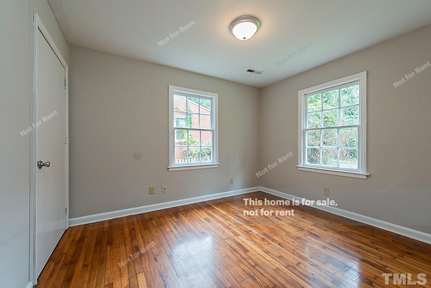 1217 Brighton Road Raleigh, NC 27610 - Photo 4 of 14 an empty room with wooden floor and windows