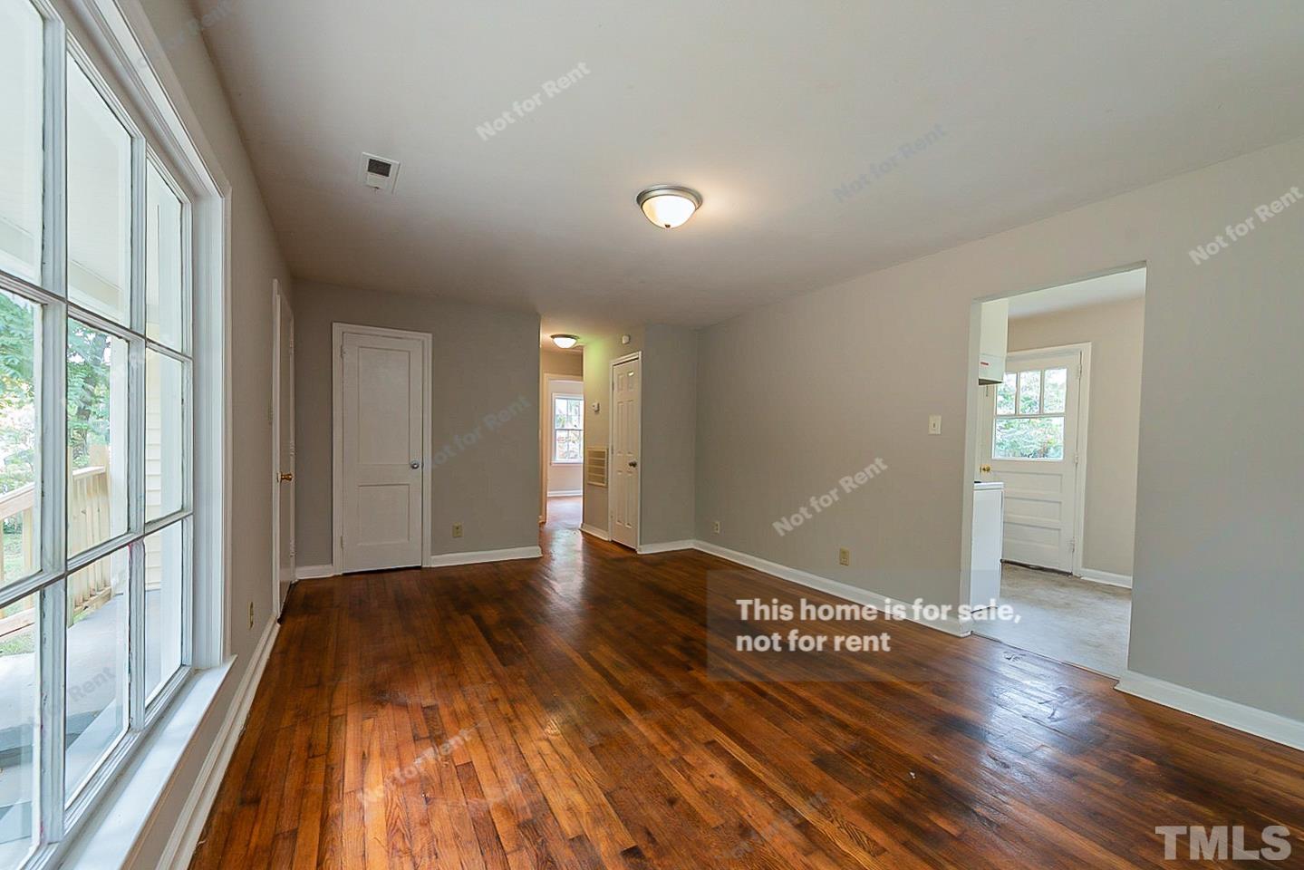 1217 Brighton Road Raleigh, NC 27610 - Photo 7 of 14 a view of an empty room with wooden floor and a window