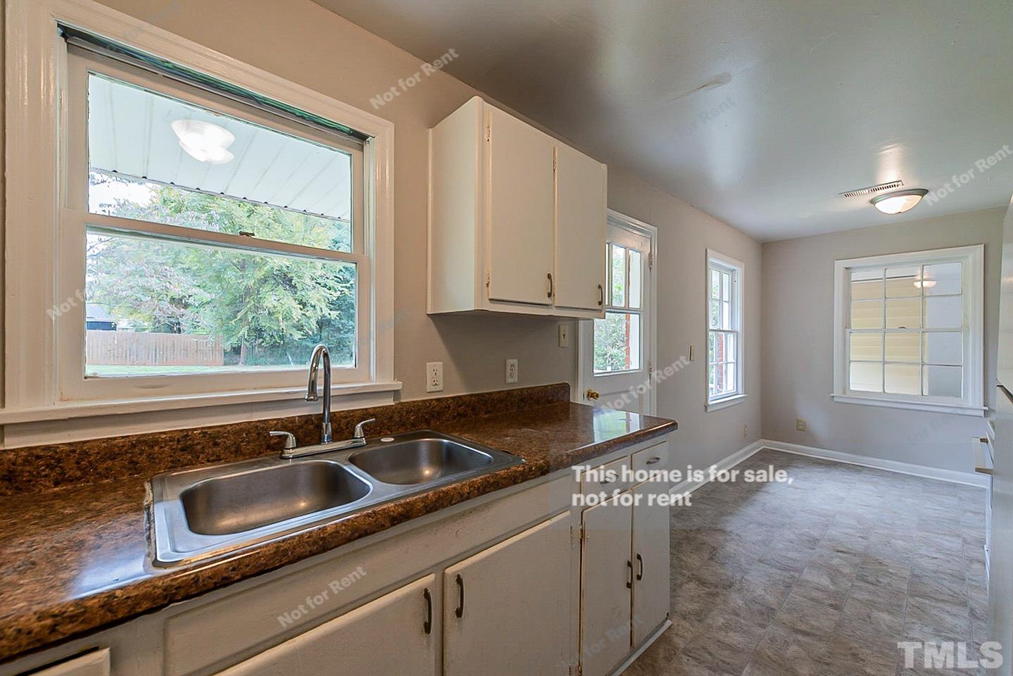 1217 Brighton Road Raleigh, NC 27610 - Photo 9 of 14 a kitchen with granite countertop a sink and a window