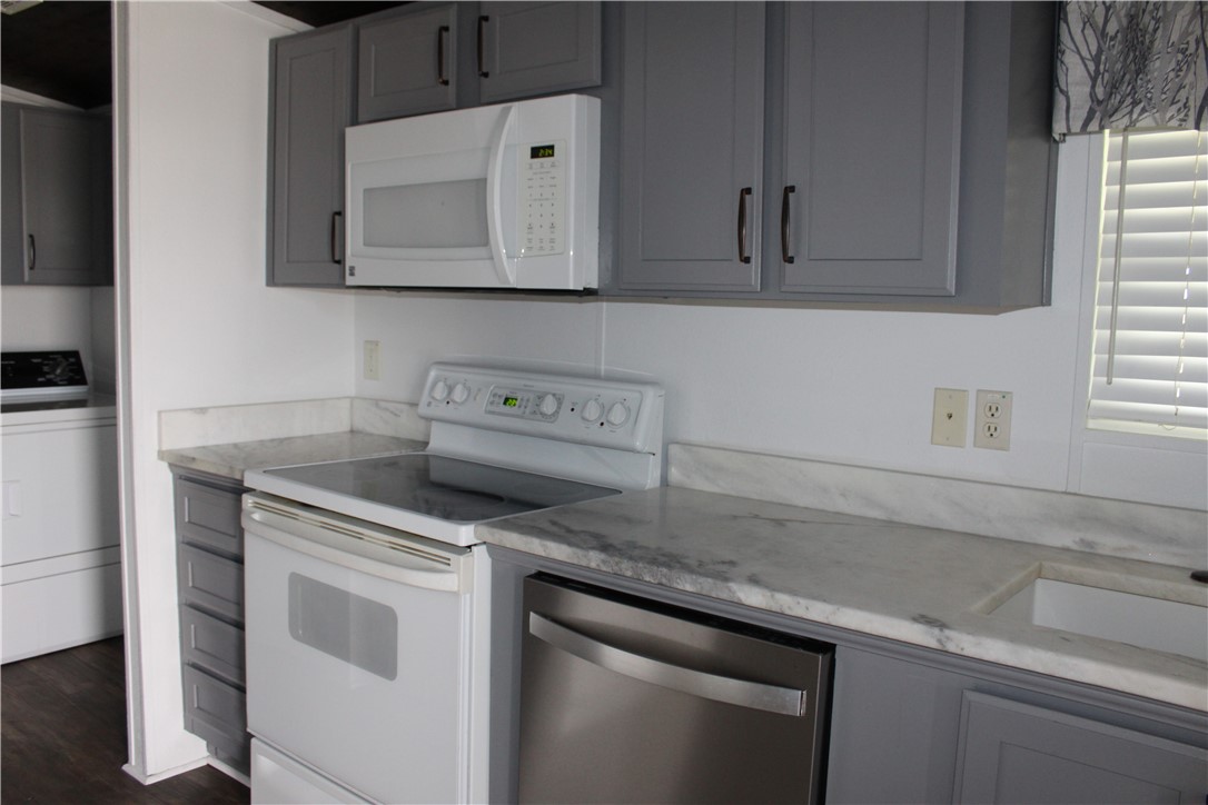 125 Lagarto Ferry Mathis, TX 78368 - Photo 11 of 38 a kitchen with granite countertop cabinets stainless steel appliances and a sink