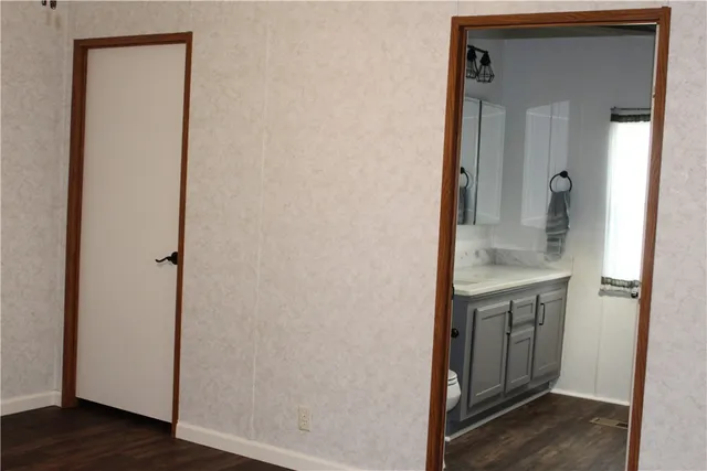 a view of bathroom with a sink and mirror