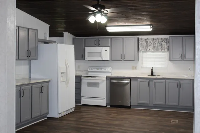 a kitchen with a refrigerator sink and cabinets
