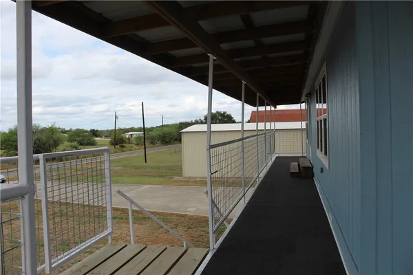 a roof deck with table and chairs