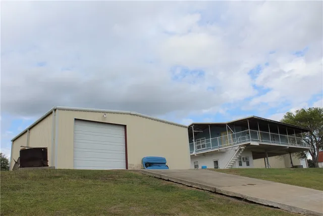 a view of house with roof deck and dining room
