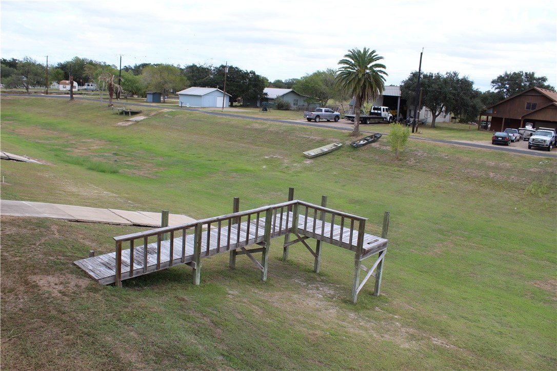 125 Lagarto Ferry Mathis, TX 78368 - Photo 5 of 38 a view of a swimming pool with lawn chairs and a big yard