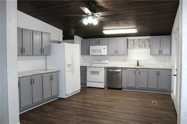 a kitchen with a white cabinets stove and refrigerator