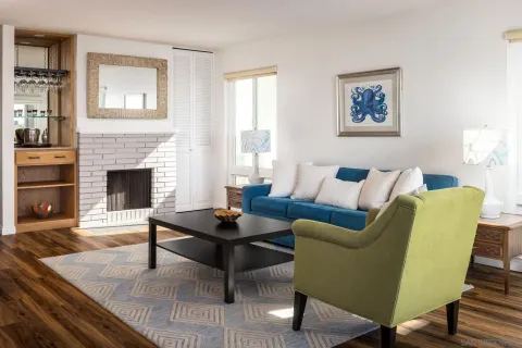 a living room with furniture a fireplace and a table