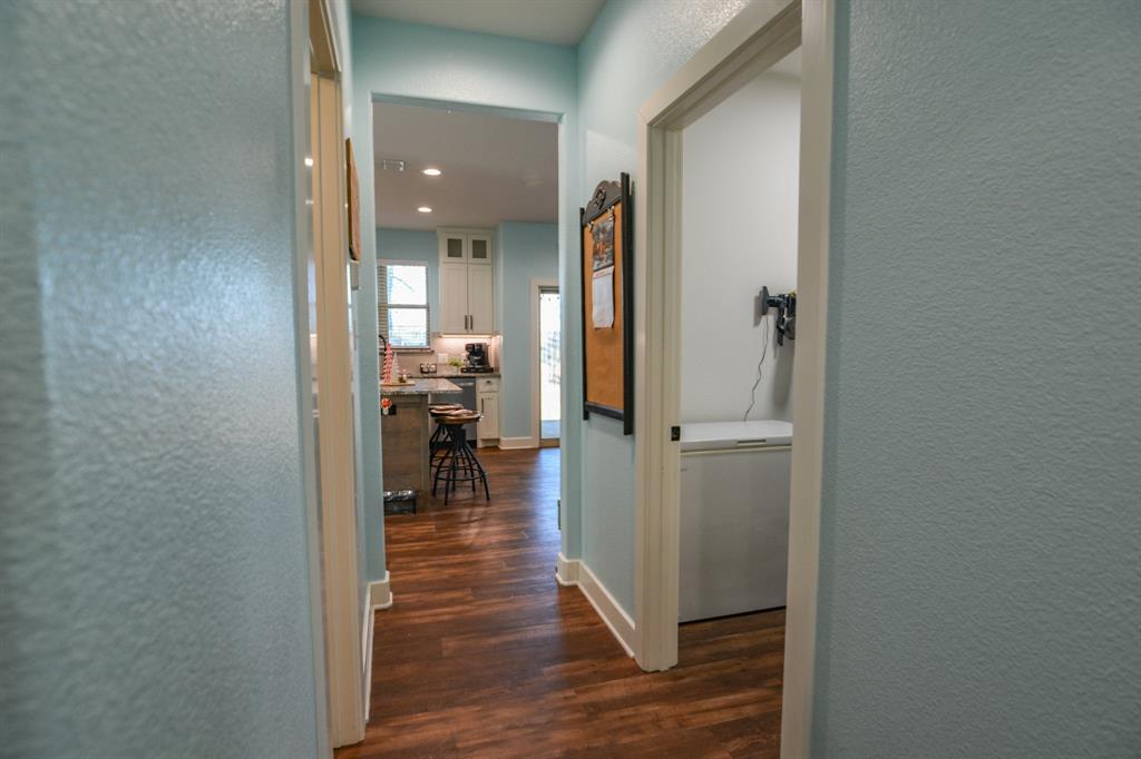 601 Mathew Street Grandview, TX 76050 - Photo 32 of 40 a view of a hallway with wooden floor a fireplace and entryway