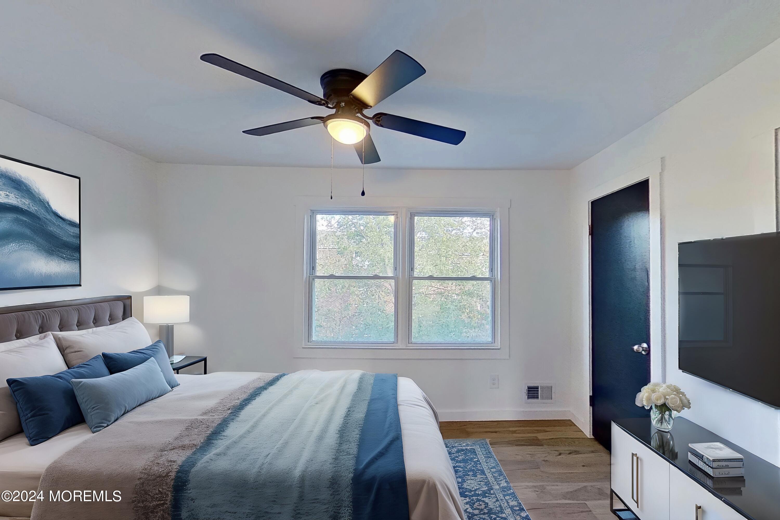 178 Sawmill Road, Unit 529 Brick, NJ 08724 - Photo 13 of 46 a bedroom with a bed and a flat screen tv