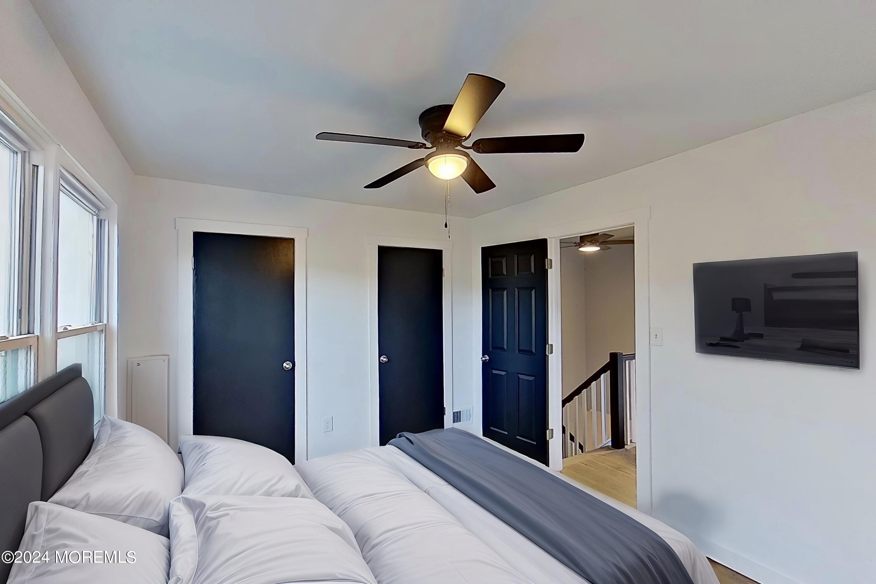 178 Sawmill Road, Unit 529 Brick, NJ 08724 - Photo 14 of 46 a bedroom with bed and a chandelier
