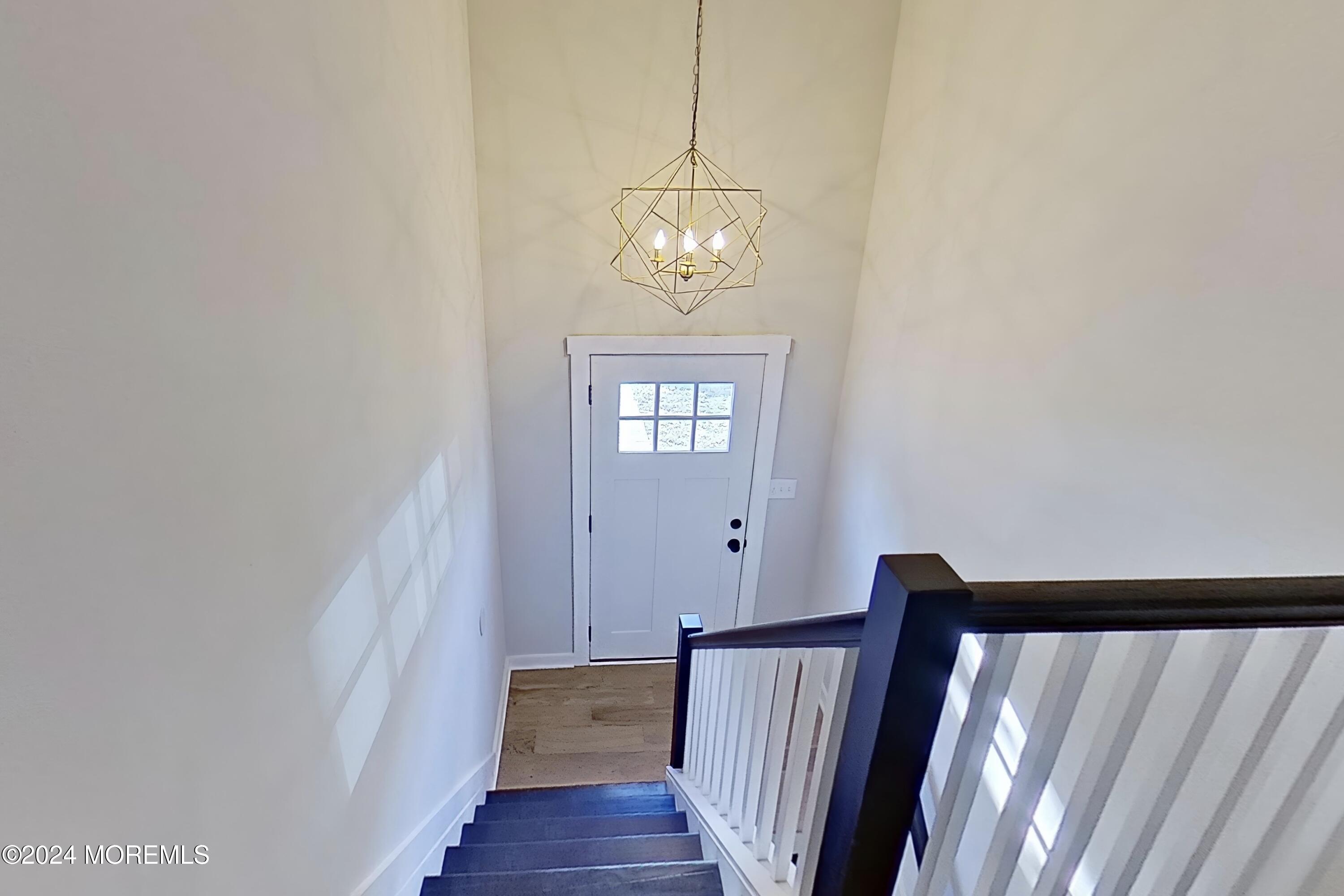 178 Sawmill Road, Unit 529 Brick, NJ 08724 - Photo 28 of 46 a view of a hallway with wooden floor and staircase