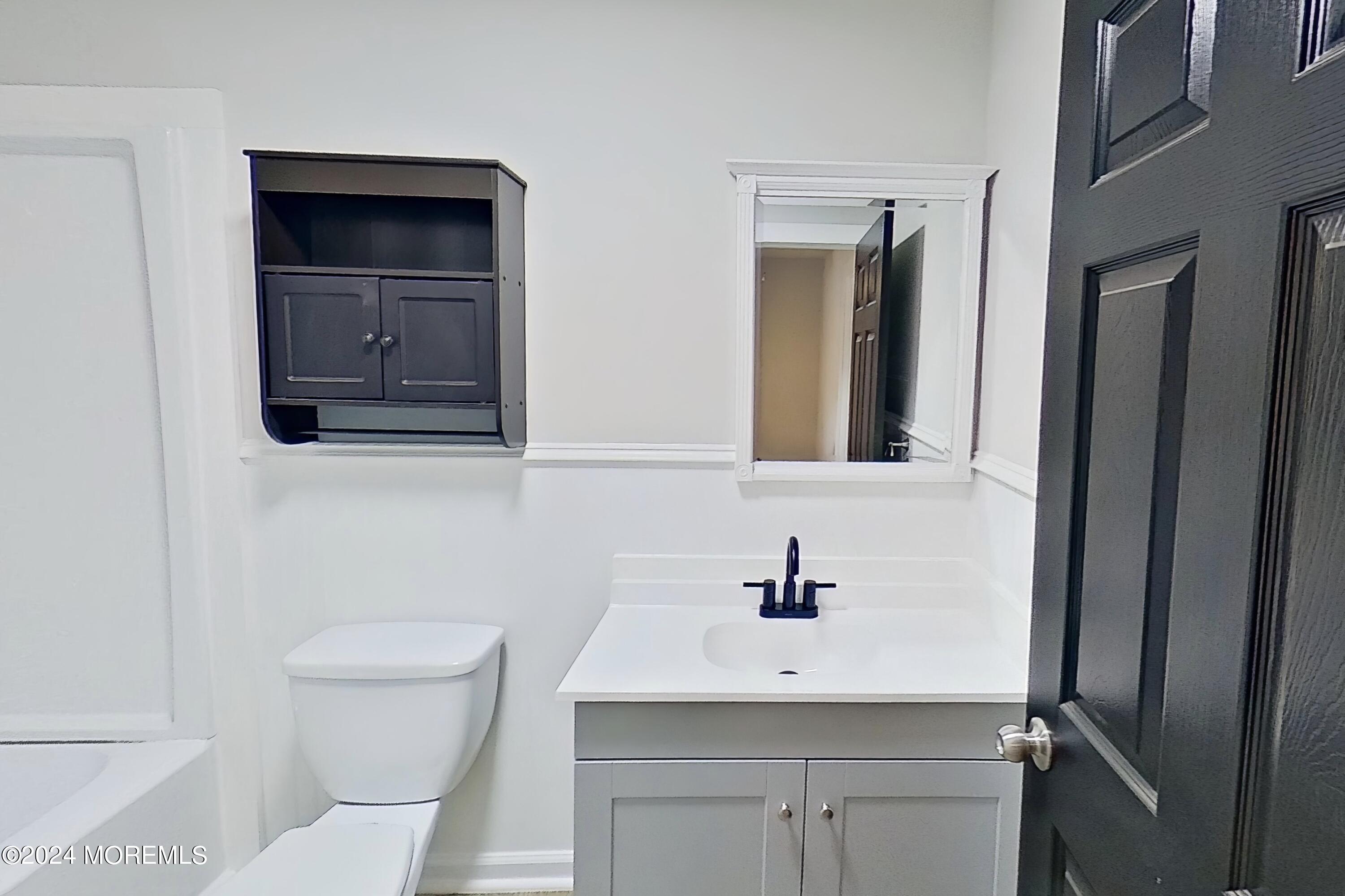 178 Sawmill Road, Unit 529 Brick, NJ 08724 - Photo 32 of 46 a bathroom with a toilet sink and mirror