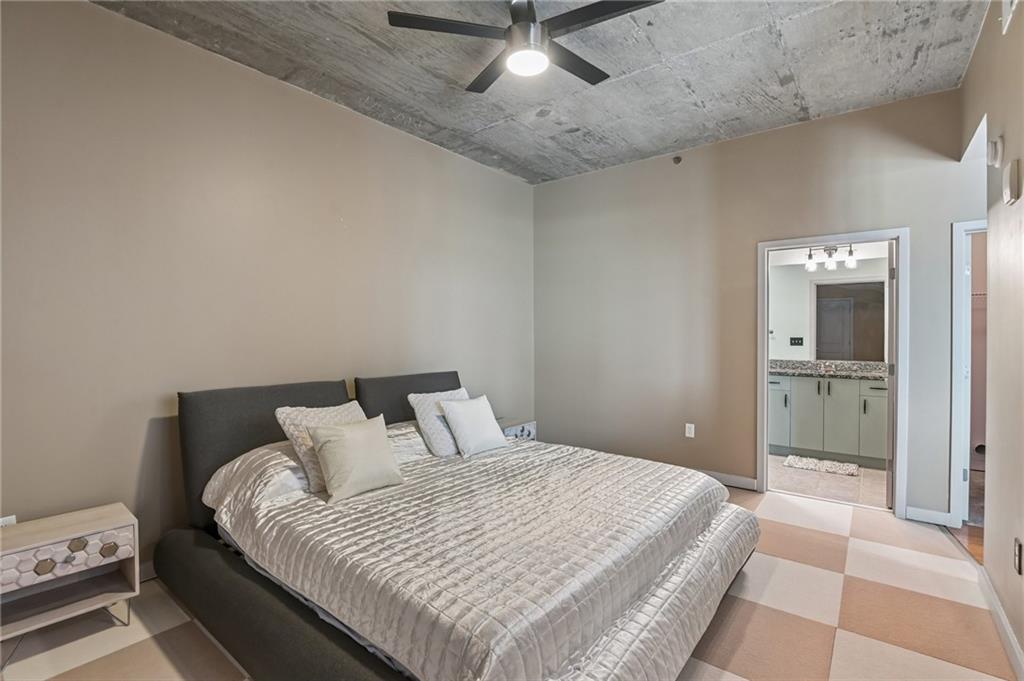 250 Pharr Road Northeast, Unit 701 Atlanta, GA 30305 - Photo 9 of 21 a bedroom with a bed and a chandelier