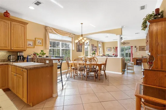 a dining room with furniture and a floor to ceiling window