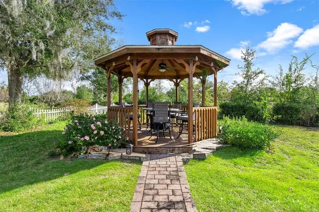 a view of a hallway to a livingroom with furniture