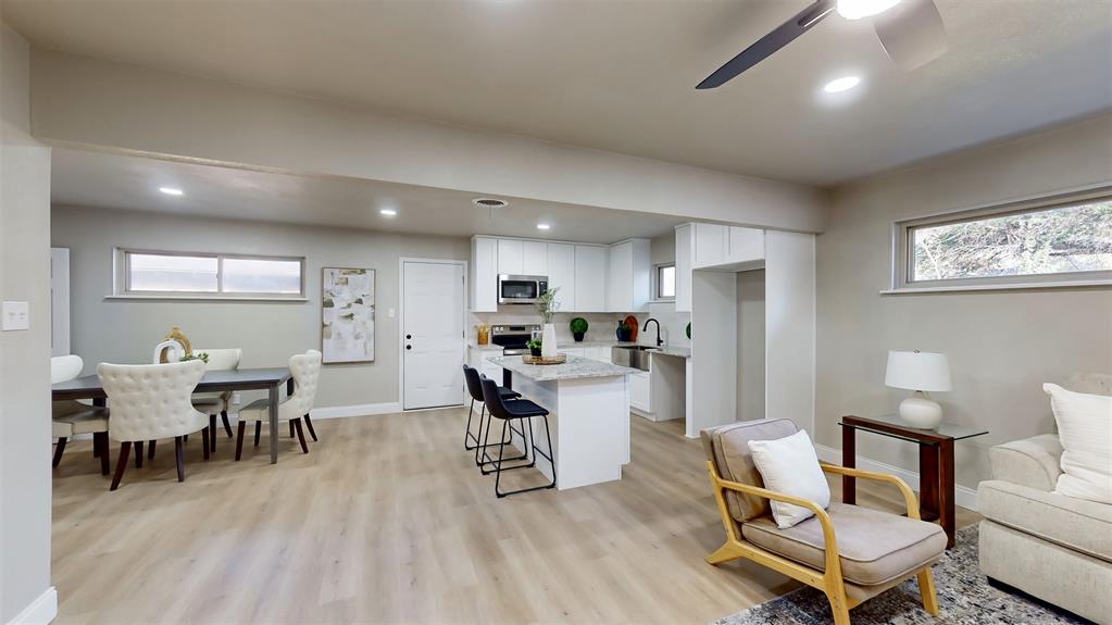 5009 Roxie Street Haltom City, TX 76117 - Photo 11 of 39 a living room with furniture a dining table and kitchen view