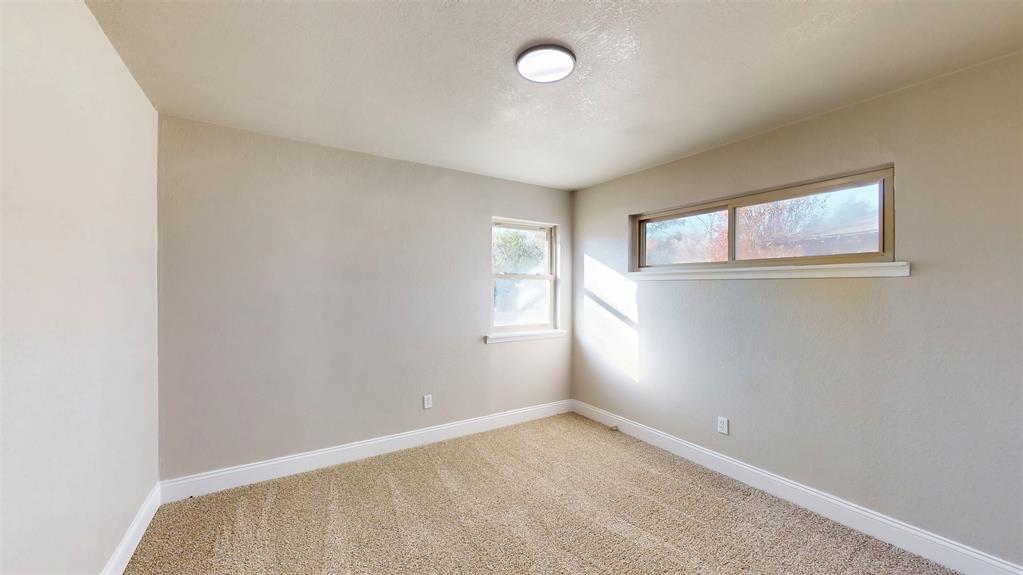 5009 Roxie Street Haltom City, TX 76117 - Photo 25 of 39 an empty room with windows